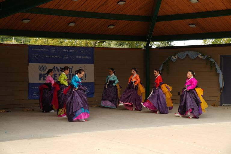 Dancers in traditional dress perform on stage