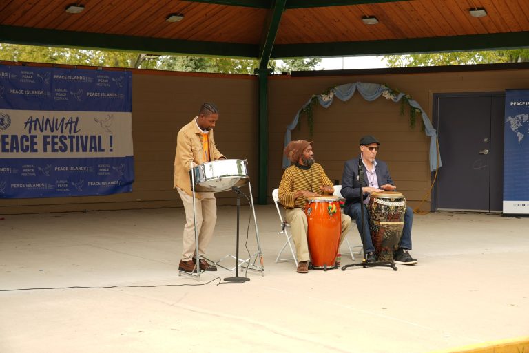 Musicians perform with steel pan and drums