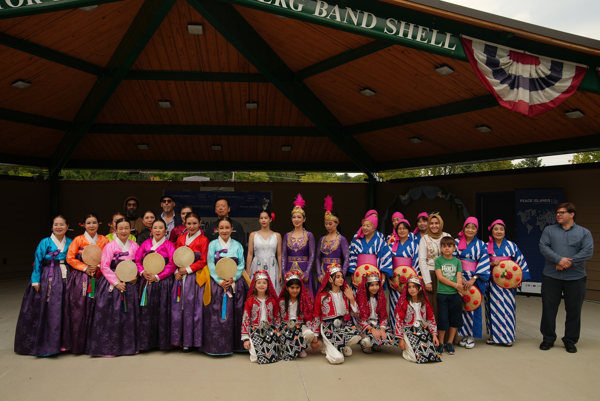 Performers from several cultural groups gather for a photo