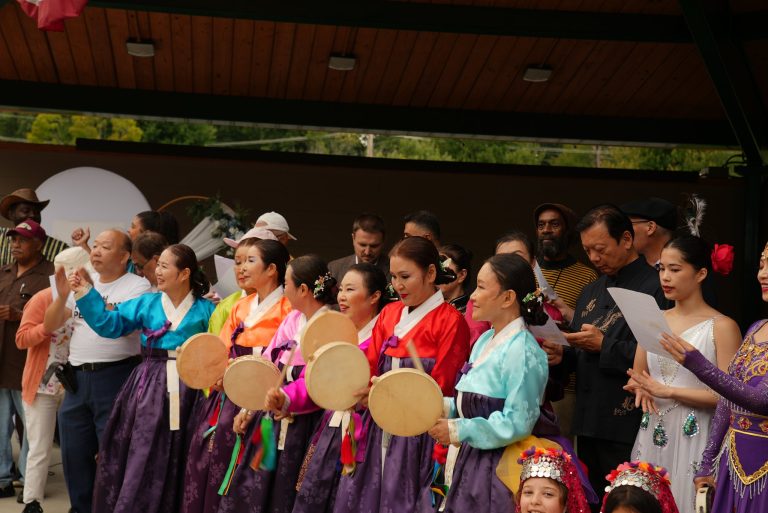 Performers and guests sing together on stage