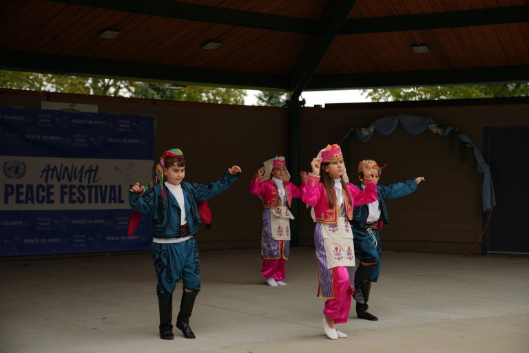 Children perform a traditional folk dance in colorful costumes